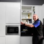 Matt Green unveils Everett Rovers' new kitchen.