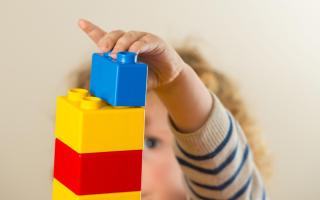 A preschool age child playing with plastic building blocks (Dominic Lipinski/PA)