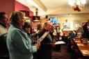 Church carol singers perform to local pub-goers