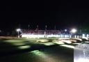 The floodlit 18th green during the Hero Challenge.