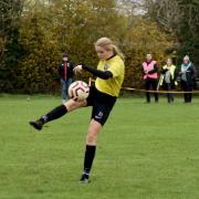 Matilda Walker volleying home for the U16 Warriors against Harpenden Colts in the County Cup.