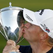 A celebratory kiss: Alex Noren with the British Masters trophy. Picture: Action Images