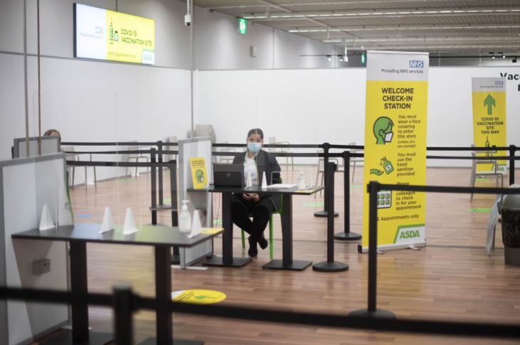 Pictured is the booking-in area at the vaccination centre at Asda in Watford. Credit: PA