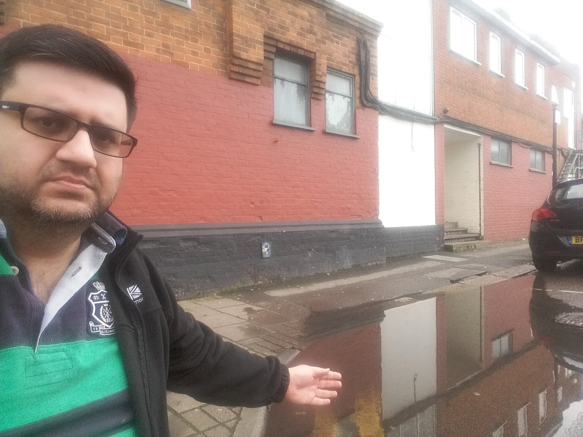 Cllr Khan pictured at the site in question before the pandemic, with flooding still an issue now