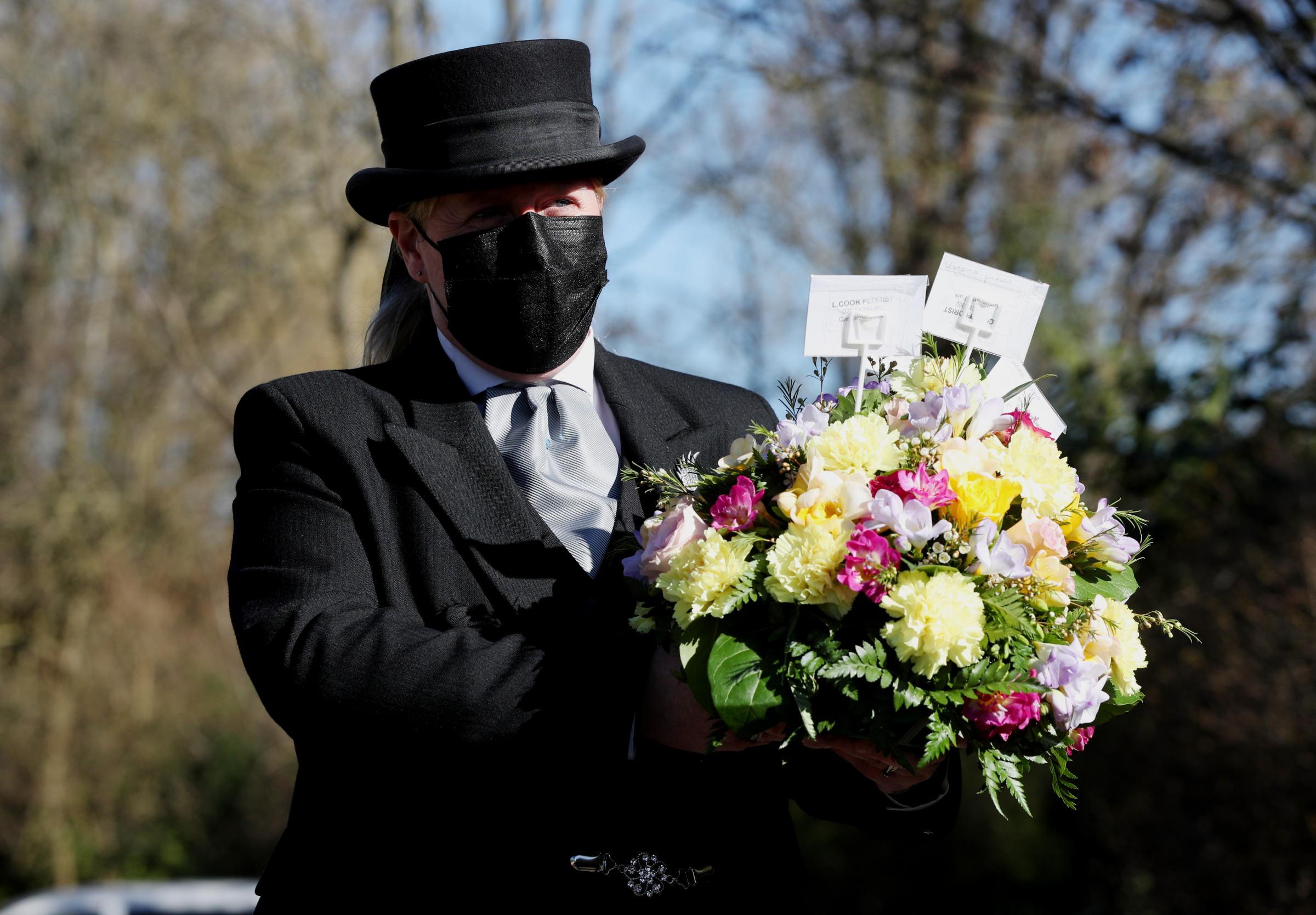 Funeral Director Colette Sworn gathers a floral tribute. Photo: PA