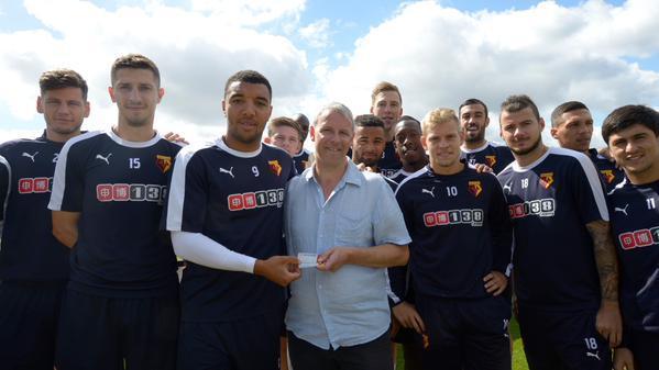 Nic Cruwys receives a pair of season tickets from Watford skipper Troy Deeney in the summer. Photo: Watford FC
