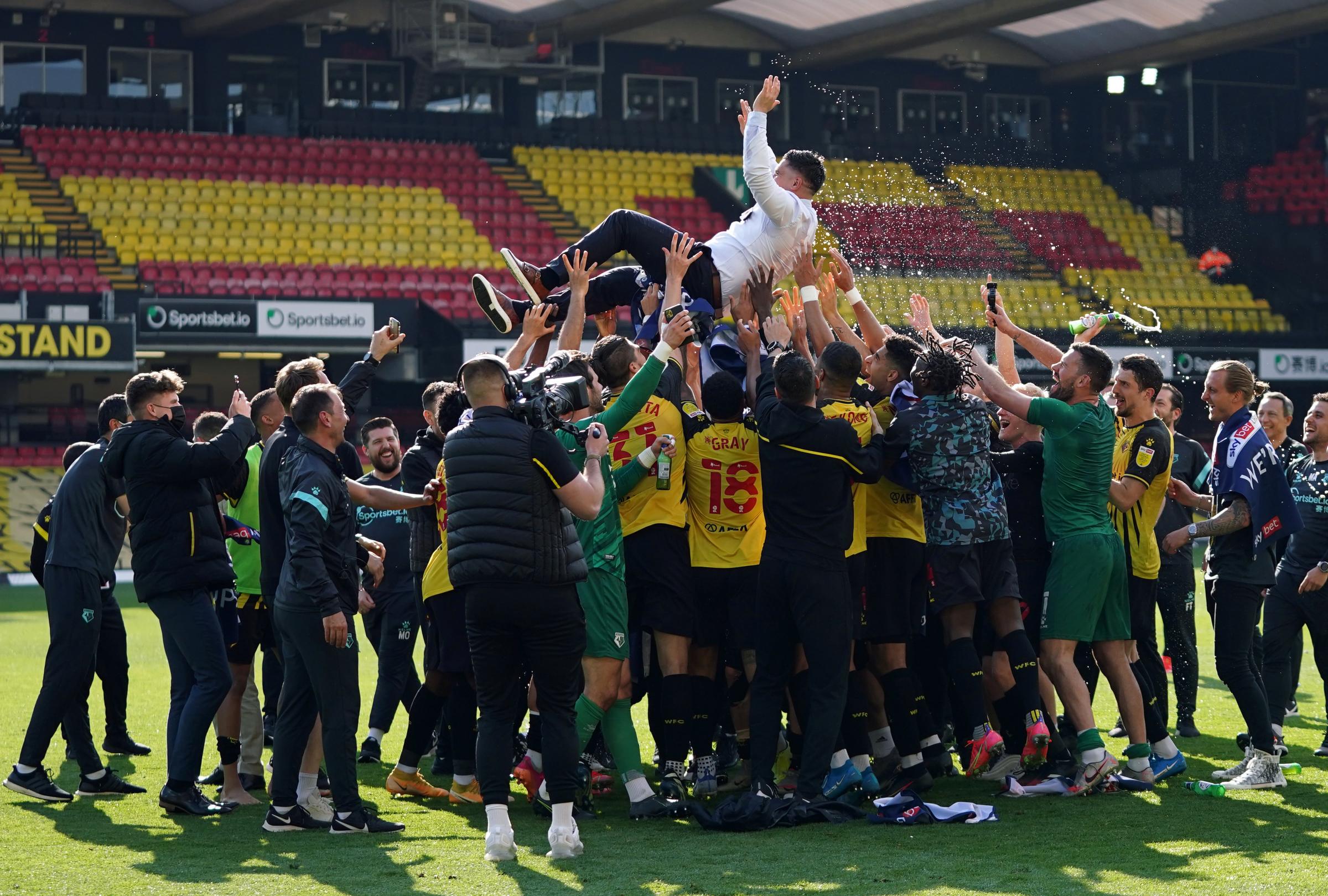 Manager Xisco is thrown in their air in celebration at the final whistle following their confirmed promotion. Photo: PA