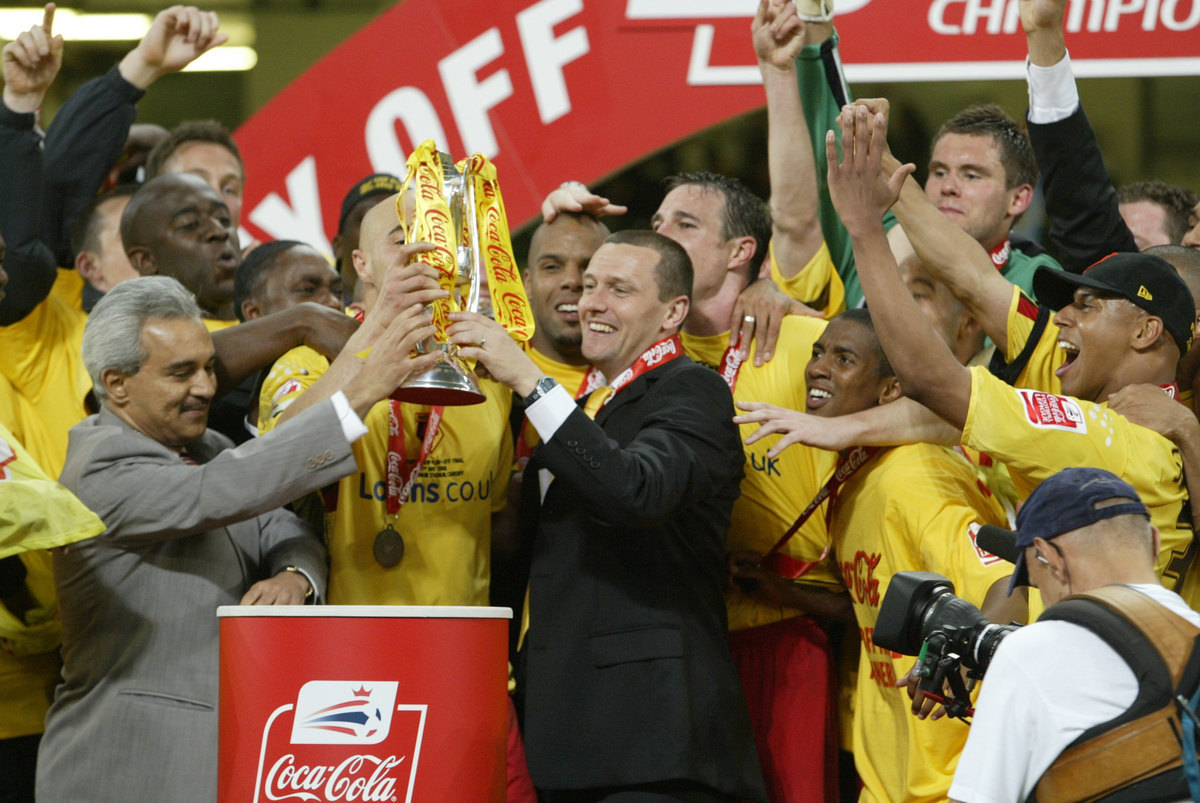 Aidy Boothroyd lifts the play-off trophy