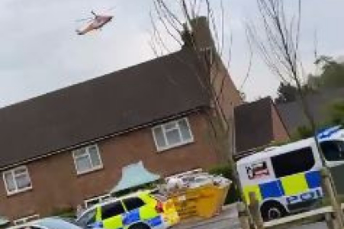 A helicopter can be seen landing close to the scene of where a teenager was found injured