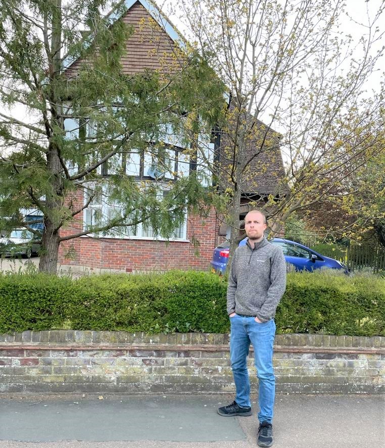 Councillor Tom Osborn pictured outside the property in April 