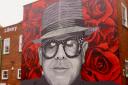 Sir Elton John mural painted on the side on town centre building