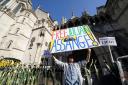 Supporters of Julian Assange outside the Royal Courts of Justice in London, ahead of the latest stage of his US extradition legal battle (Lucy North/PA)
