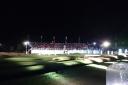 The floodlit 18th green during the Hero Challenge.