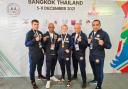 Victorious Ellie Harber, 16, pictured with coaches from the United Kingdom Muay Thai Federation