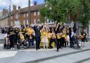 Electric Umbrella members celebrate previous street piano launch