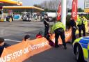 Campaigners staging a protest in the Shell petrol garage at Cobham Services on the M25 in Surrey