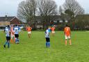 The Cross (blue and white shirts) moved six points clear at the top of Division Two by beating King George.