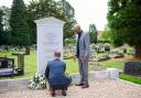 Peter Taylor and Luther Blissett lay a wreath at the restored memorial