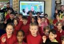 Youngsters at Woodhall School with the Florida-based office on screen