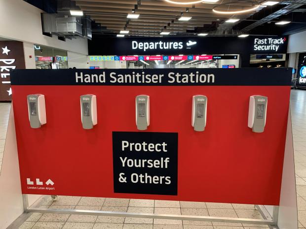 Watford Observer: A hand sanitising station at London Luton Airport