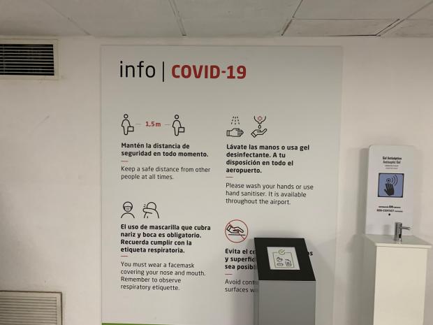 Watford Observer: An information sign about Covid-19 at Malaga Airport