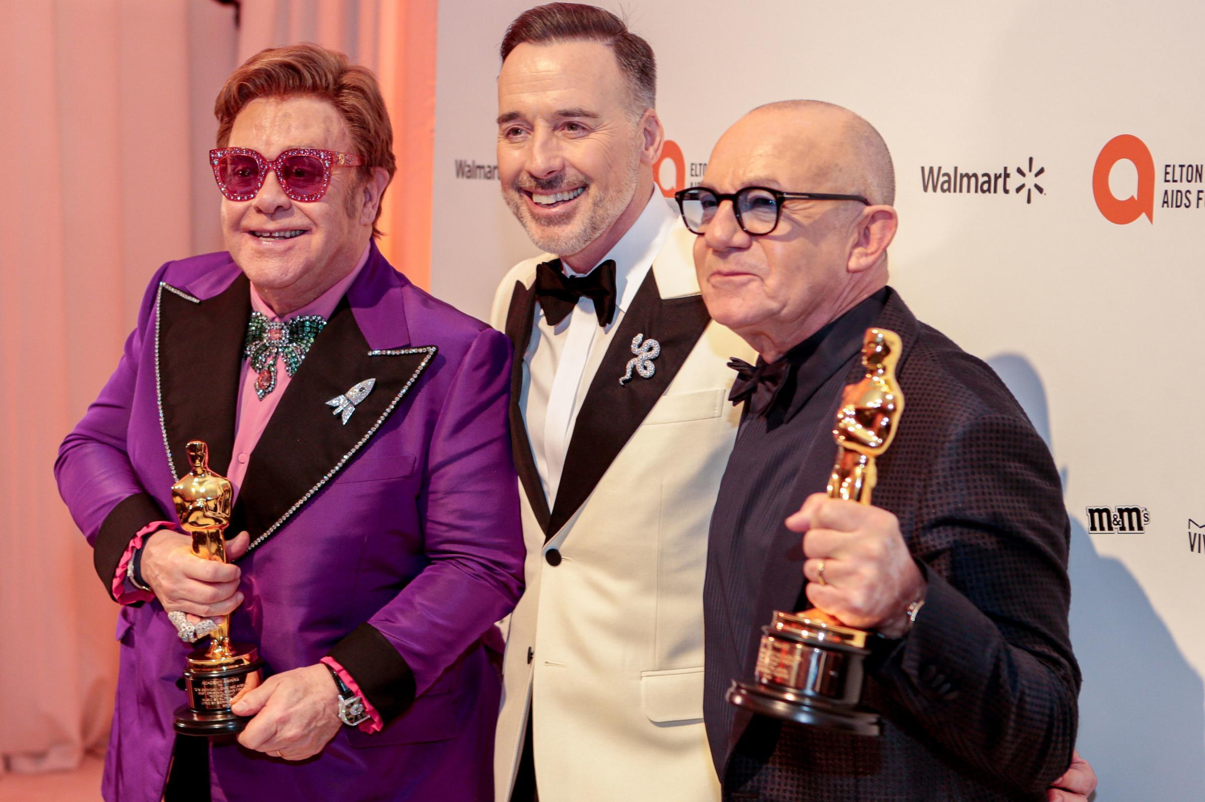 Elton John, David Furnish and Bernie Taupin celebrate the win (Photo: PA Wire)