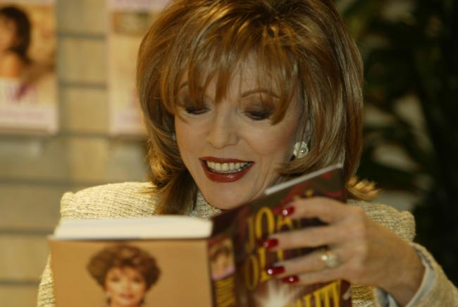 The smiling star signs a copy of Joan's Way. Pictures: Jane Parr