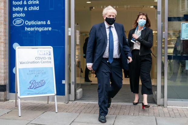 Watford Observer: Prime Minister Boris Johnson leaving the Boots Pharmacy vaccination clinic in Uxbridge, west London, today. Credit: PA