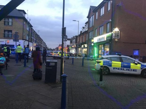 Watford Observer: Police cordon in Queens Road, Watford, where the victim got to before going into the Costcutter for first aid. Credit: JamPond Photography