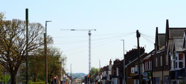 Watford Observer: A crane at Berkeley Homes' redevelopment as seen from Leavesden Road. The buildings are also set to be visible from places such as Bushey and The Grove Credit: Stephen Danzig