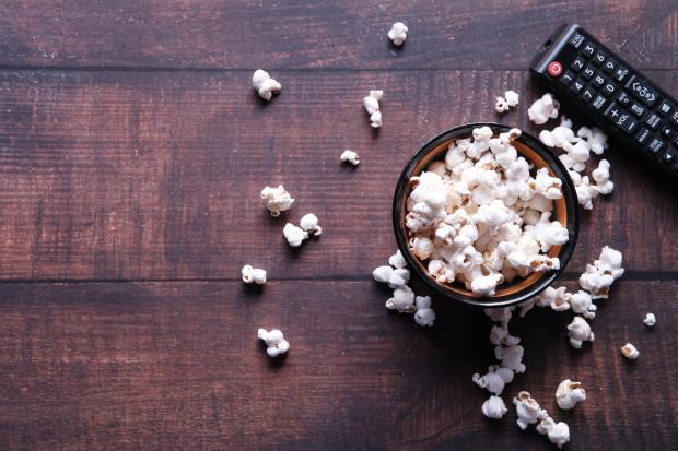 Watford Observer: A bowl of popcorn and a TV remote (Canva)