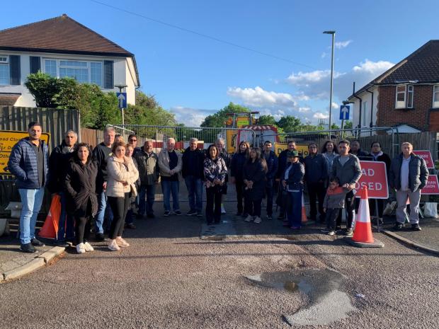 Watford Observer: Residents want Pike Road, pictured behind them, reopened by TfL. The street is being used to store maintenance vehicles involved in the bridge repairs