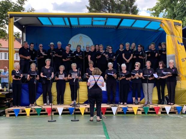 Watford Observer: Kings Langley Community Choir on stage 2019. Picture: Kings Langley Carnival Facebook page