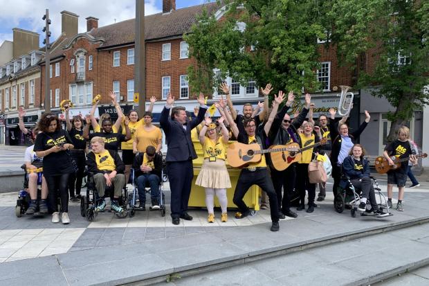 Electric Umbrella members celebrate previous street piano launch