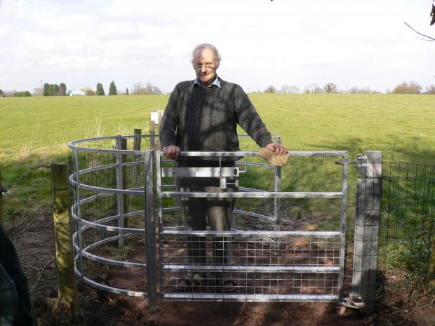 Watford Observer: Chris Beney with a new kissing gate near Farm Way, Bushey. Picture: Colin Knight