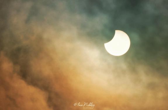 Watford Observer: 'Partial solar eclipse, with a touch of autumnal colour in the clouds.' Watford Observer: 'Partial solar eclipse, with a touch of autumnal colour in the clouds.'