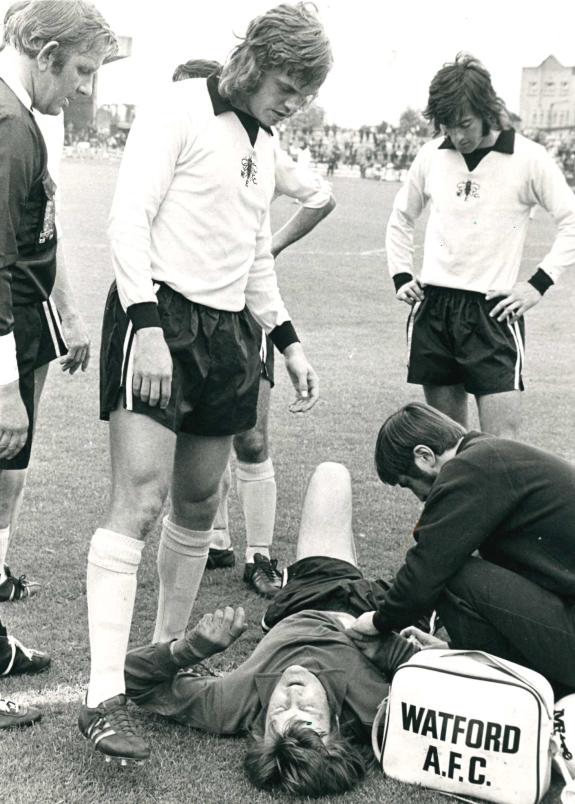 Watford Observer: Concerned teammates gather round as Rankin receives treatment Watford Observer: Concerned teammates gather round as Rankin receives treatment