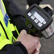Speed gun held by police officer stock image.