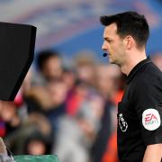 Referee Andy Madley refers to the VAR monitor. Picture: Action Images