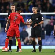 Graham Scott hands Joshua King the matchball following his hat-trick in the victory at Goodison Park. Picture: Action Images