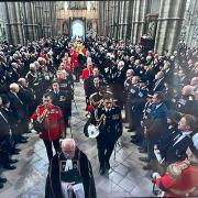 Lord-Lieutenant Robert Voss is pictured front right in Westminster Abbey as the Queen's coffin is brought through. Image: BBC