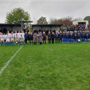The two Guardsmen with the Garry Beadle Memorial Trophy as the two teams line up ahead of the game.