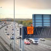 Just Stop Oil protesters on a gantry above the M25. Image: PA
