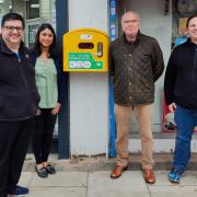 Councilor Asif Khan, Purvi Barchha from FT Taylor Pharmacy, Colin Turner, chair of Courtlands Residents Association and Councillor Richard Smith with the defibrillator.
