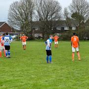 The Cross (blue and white shirts) moved six points clear at the top of Division Two by beating King George.