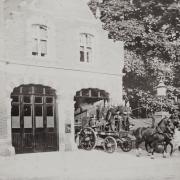 A horse-drawn fire engine responds to an emergency