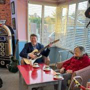Dean Russell, MP for Watford, grabs the guitar to entertain residents at Courtland Lodge Care Home