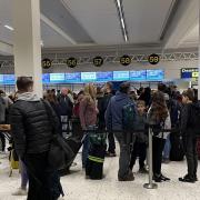 Passengers queue inside the departures area of Terminal 1 at Manchester Airport.