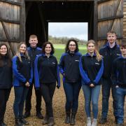 The volunteers in front of the new barn doors which have been installed due to funding from Grundon
