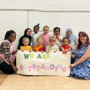 Precious playdays team and kids celebrate the 'outstanding' rating.